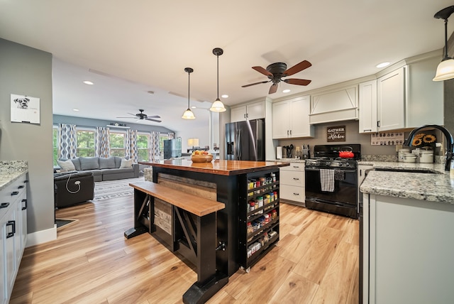 22 Westray Dr, Nashua, NH 03062 - kitchen with black range with gas stovetop, stainless steel fridge with ice dispenser, a ceiling fan, a sink, and recessed lighting