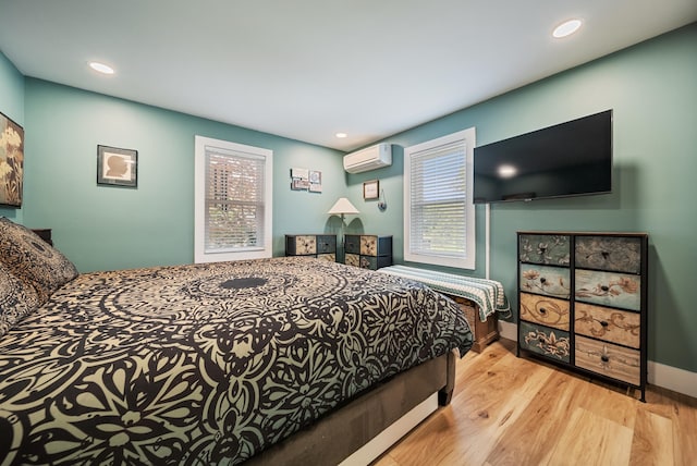 22 Westray Dr, Nashua, NH 03062 - bedroom featuring a wall mounted AC, wood finished floors, recessed lighting, and baseboards