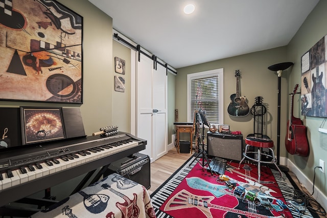 22 Westray Dr, Nashua, NH 03062 - living area with a barn door, light wood-style flooring, and baseboards
