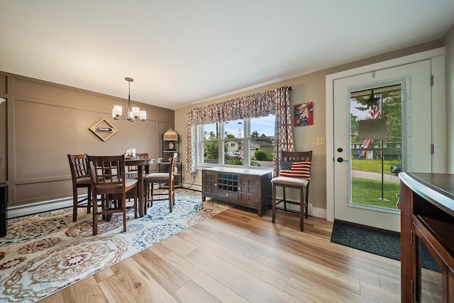 22 Westray Dr, Nashua, NH 03062 - dining room with a chandelier, wood finished floors, and a baseboard heating unit