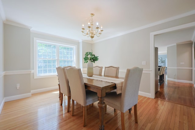 7 Adella Dr, Nashua, NH 03063 - dining room with a chandelier, light wood finished floors, baseboards, and ornamental molding