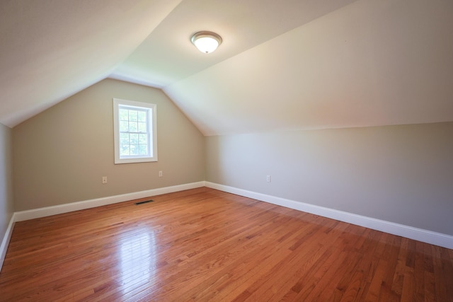 7 Adella Dr, Nashua, NH 03063 - bonus room with light wood-style flooring, vaulted ceiling, and baseboards