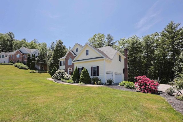 7 Adella Dr, Nashua, NH 03063 - view of front of home featuring a front lawn, a chimney, an attached garage, and driveway