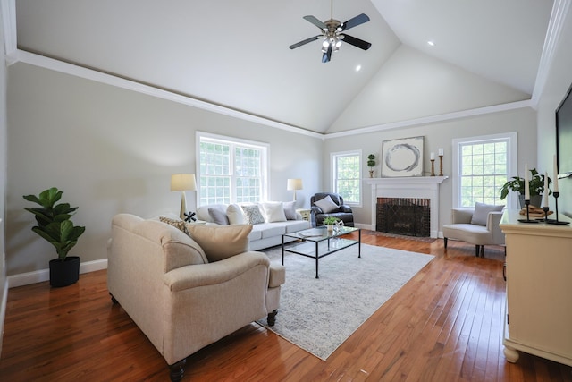 7 Adella Dr, Nashua, NH 03063 - living area featuring high vaulted ceiling, plenty of natural light, a brick fireplace, a ceiling fan, and recessed lighting