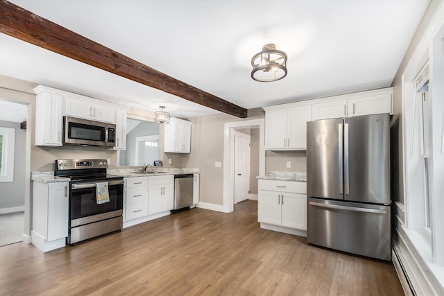 9 Grove Rd, Lyndeborough, NH 03082 - kitchen with stainless steel appliances, a sink, baseboards, light wood finished floors, and beam ceiling