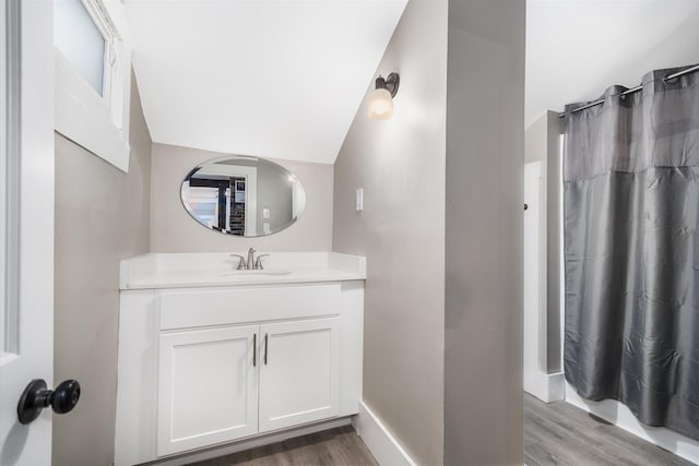 9 Grove Rd, Lyndeborough, NH 03082 - full bathroom with wood finished floors, vanity, a shower with curtain, vaulted ceiling, and baseboards
