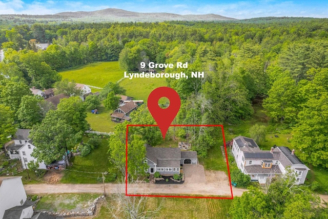 9 Grove Rd, Lyndeborough, NH 03082 - aerial view of property and surrounding area featuring a heavily wooded area and property parcel outlined