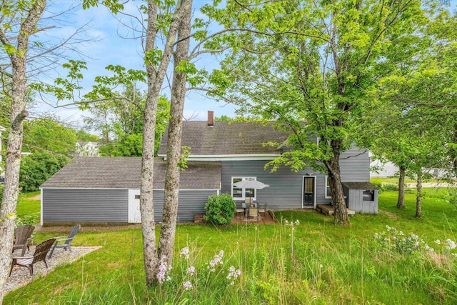 9 Grove Rd, Lyndeborough, NH 03082 - back of house featuring a chimney, roof with shingles, and a yard
