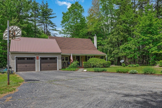 780 Greenfield Rd, Peterborough, NH 03458 - view of front of home with a garage, a chimney, covered porch, and driveway