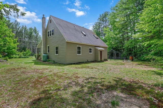 780 Greenfield Rd, Peterborough, NH 03458 - view of side of property featuring a chimney, roof with shingles, and a lawn