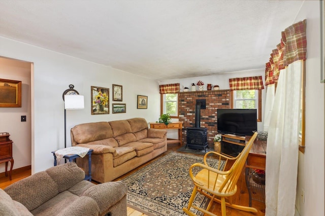 780 Greenfield Rd, Peterborough, NH 03458 - living area with a wood stove, healthy amount of natural light, and wood finished floors