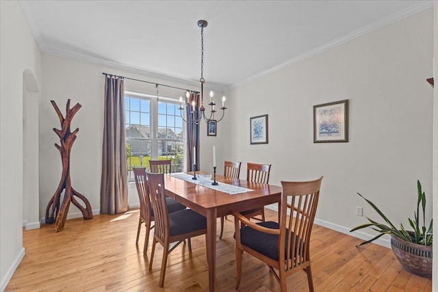 168 Raven Cir, Williston, VT 05495 - dining room with light wood finished floors, a chandelier, crown molding, and baseboards