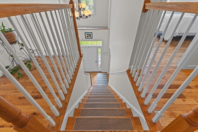 168 Raven Cir, Williston, VT 05495 - staircase featuring baseboards, a high ceiling, and a chandelier