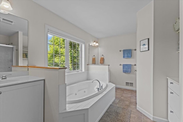 168 Raven Cir, Williston, VT 05495 - bathroom featuring vanity, a jetted tub, a shower stall, and baseboards
