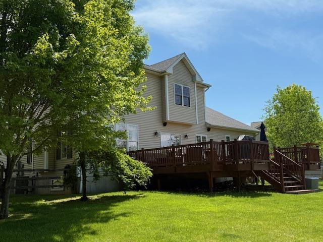 168 Raven Cir, Williston, VT 05495 - rear view of property featuring a wooden deck, a yard, and stairs