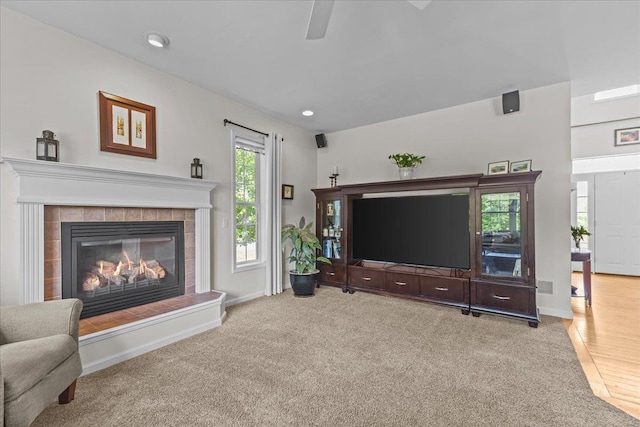 168 Raven Cir, Williston, VT 05495 - carpeted living area featuring a tiled fireplace, baseboards, ceiling fan, and recessed lighting
