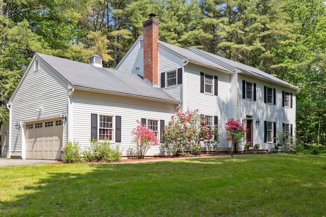 179 Arbor Ln, Colchester, VT 05446 - colonial home with a chimney, a front yard, an attached garage, and asphalt driveway