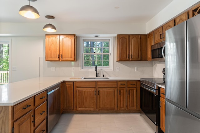 179 Arbor Ln, Colchester, VT 05446 - kitchen featuring appliances with stainless steel finishes, a sink, a peninsula, and light countertops