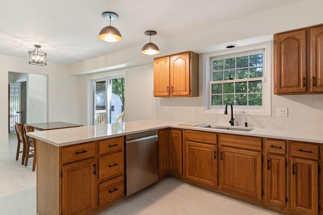 179 Arbor Ln, Colchester, VT 05446 - kitchen with dishwasher, a sink, a peninsula, and brown cabinetry