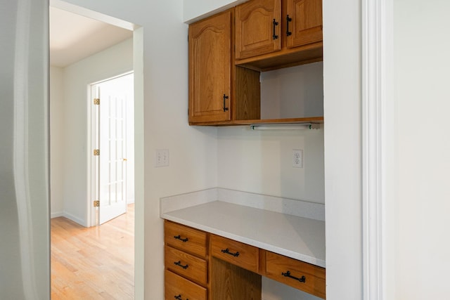 179 Arbor Ln, Colchester, VT 05446 - kitchen featuring light countertops, brown cabinets, and light wood finished floors
