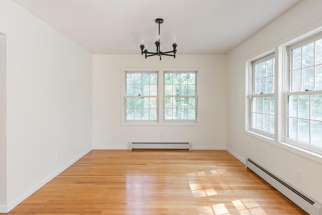 179 Arbor Ln, Colchester, VT 05446 - unfurnished dining area with a baseboard radiator, a chandelier, and healthy amount of natural light