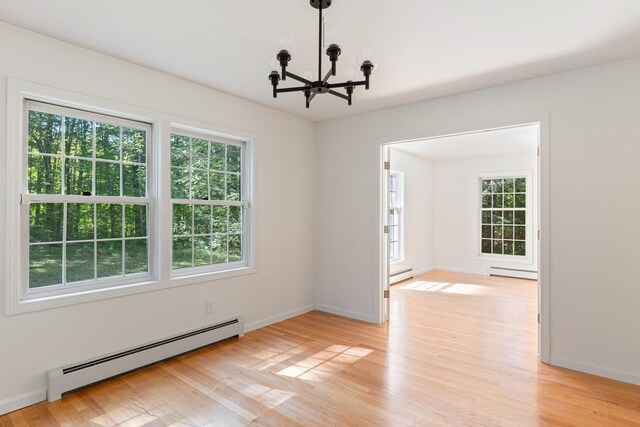 179 Arbor Ln, Colchester, VT 05446 - unfurnished room with baseboard heating, a chandelier, and plenty of natural light
