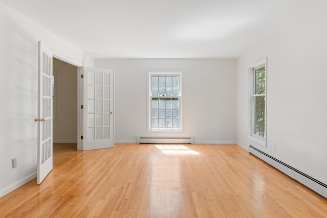 179 Arbor Ln, Colchester, VT 05446 - spare room featuring a baseboard radiator, plenty of natural light, and light wood finished floors