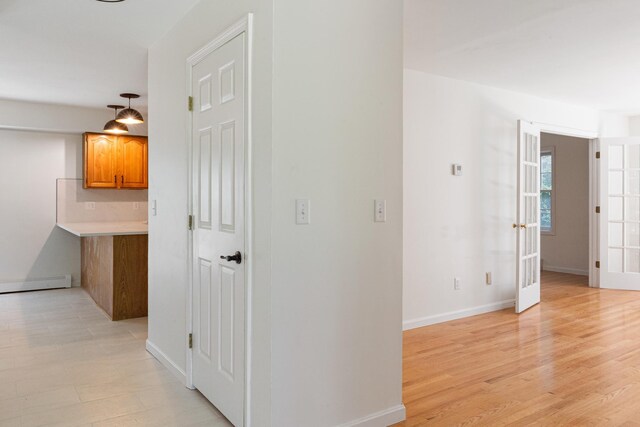 179 Arbor Ln, Colchester, VT 05446 - corridor with a baseboard heating unit, baseboards, and light wood-style flooring