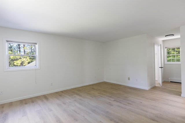 179 Arbor Ln, Colchester, VT 05446 - unfurnished room with light wood-style flooring, a baseboard radiator, and baseboards