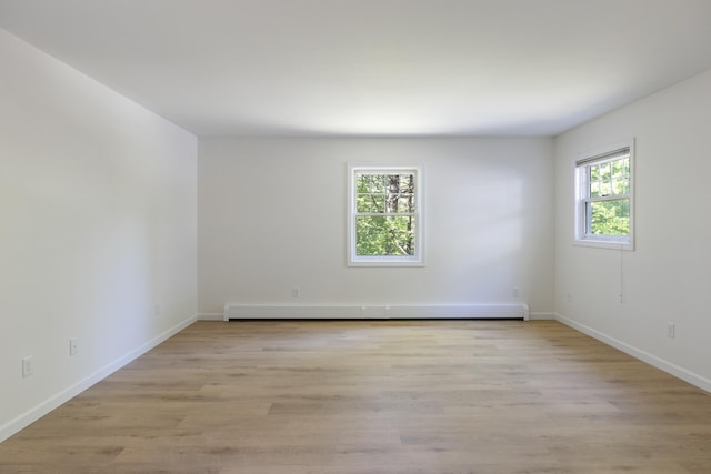 179 Arbor Ln, Colchester, VT 05446 - empty room with baseboards, light wood-style floors, and baseboard heating