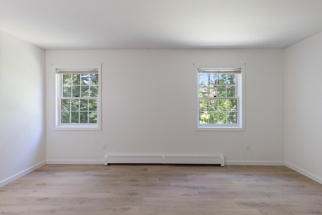 179 Arbor Ln, Colchester, VT 05446 - empty room featuring baseboard heating, plenty of natural light, and light wood-style flooring