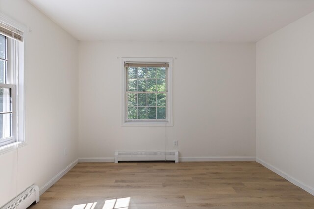 179 Arbor Ln, Colchester, VT 05446 - unfurnished room featuring baseboard heating, a baseboard radiator, light wood finished floors, and baseboards