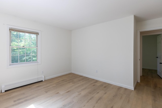 179 Arbor Ln, Colchester, VT 05446 - unfurnished room with a baseboard radiator, light wood-style flooring, and baseboards