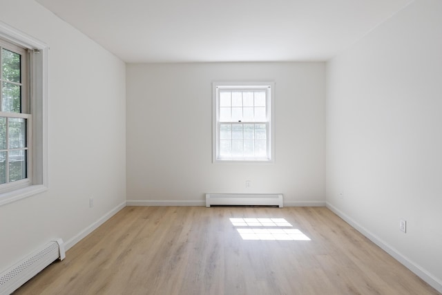 179 Arbor Ln, Colchester, VT 05446 - unfurnished room featuring a baseboard heating unit, healthy amount of natural light, and light wood-style floors