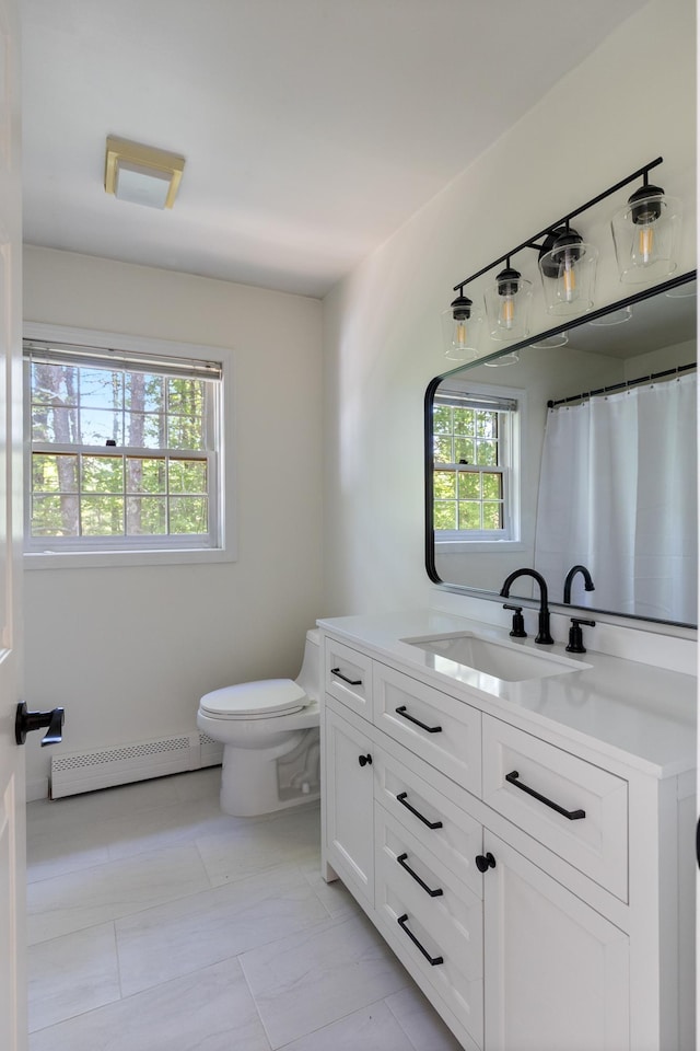179 Arbor Ln, Colchester, VT 05446 - bathroom featuring baseboard heating, plenty of natural light, vanity, and toilet