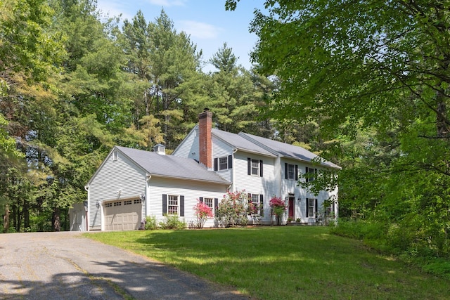 179 Arbor Ln, Colchester, VT 05446 - colonial inspired home featuring a garage, a chimney, driveway, and a front lawn