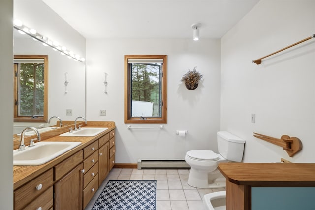 263 Old Post Rd, Newbury, NH 03255 - bathroom featuring baseboard heating, toilet, double vanity, tile patterned floors, and baseboards