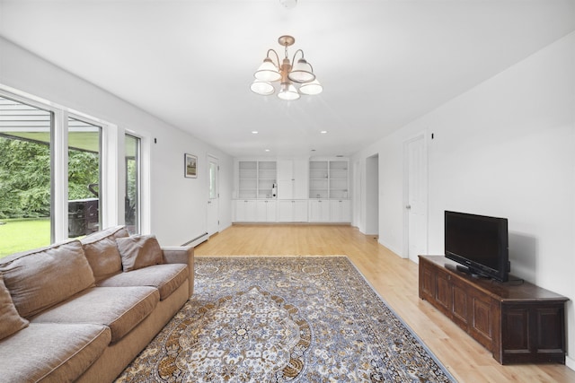 263 Old Post Rd, Newbury, NH 03255 - living area with light wood finished floors, a chandelier, baseboard heating, built in features, and baseboards