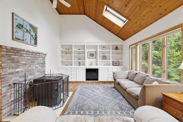 263 Old Post Rd, Newbury, NH 03255 - living room featuring high vaulted ceiling, wooden ceiling, a skylight, light wood finished floors, and a wood stove