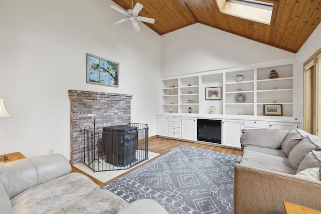 263 Old Post Rd, Newbury, NH 03255 - living room featuring high vaulted ceiling, a wood stove, ceiling fan, wood finished floors, and wooden ceiling