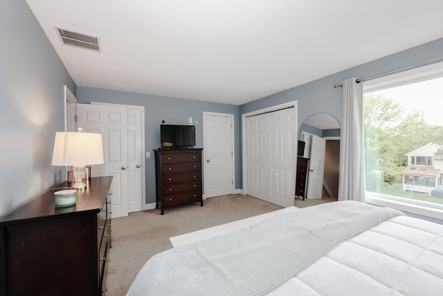 65 Victoria St Unit 8, Manchester, NH 03104 - bedroom featuring light carpet and two closets