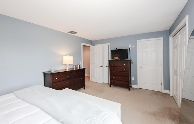 65 Victoria St Unit 8, Manchester, NH 03104 - bedroom featuring light carpet, multiple closets, and baseboards