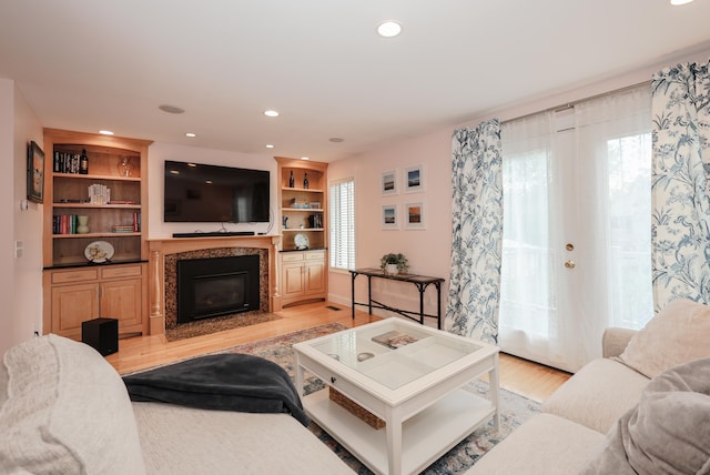 65 Victoria St Unit 8, Manchester, NH 03104 - living room featuring light wood-type flooring, a fireplace with flush hearth, and recessed lighting