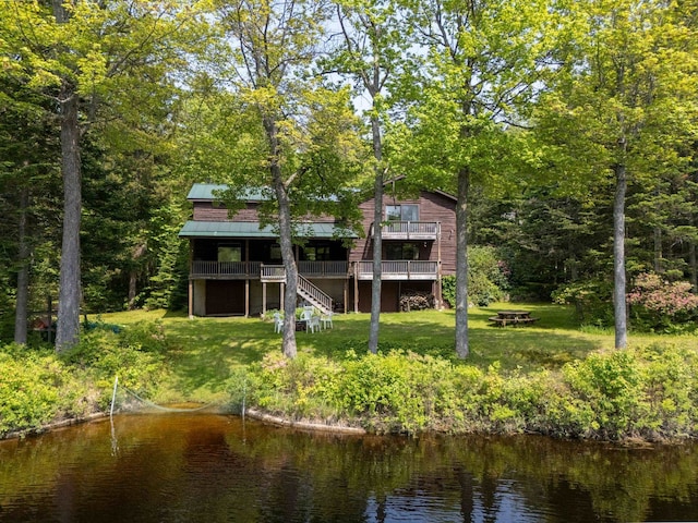 16 Mckinnon Rd, Washington, NH 03280 - rear view of house featuring stairs, a yard, a standing seam roof, a deck with water view, and metal roof