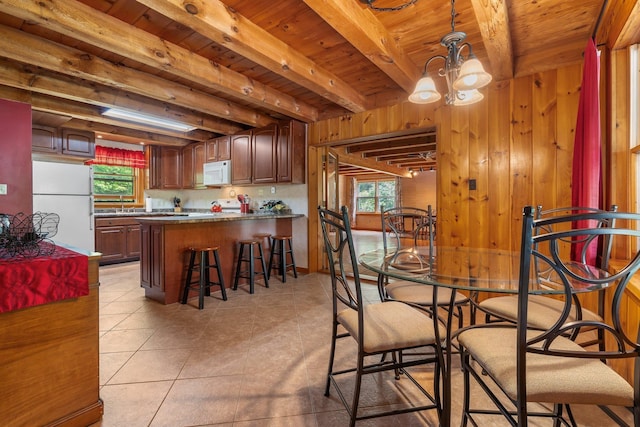 16 Mckinnon Rd, Washington, NH 03280 - dining space with wood ceiling with exposed beams, light tile patterned floors, a chandelier, and wood walls