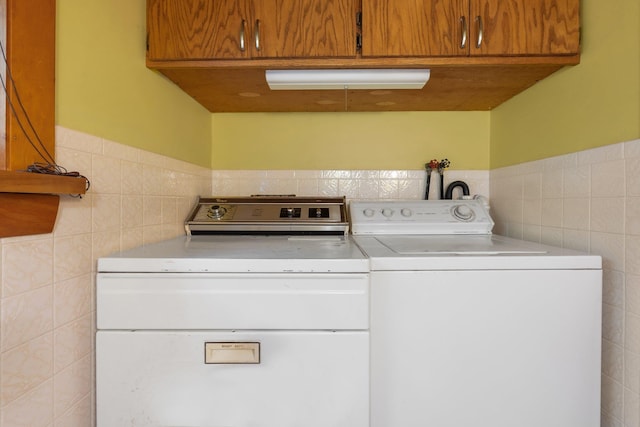 16 Mckinnon Rd, Washington, NH 03280 - washroom featuring tile walls, washing machine and dryer, cabinet space, and wainscoting