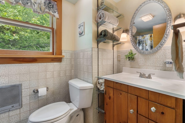 16 Mckinnon Rd, Washington, NH 03280 - bathroom featuring vanity, toilet, tile walls, heating unit, and wainscoting