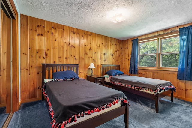 16 Mckinnon Rd, Washington, NH 03280 - carpeted bedroom with a textured ceiling and wood walls