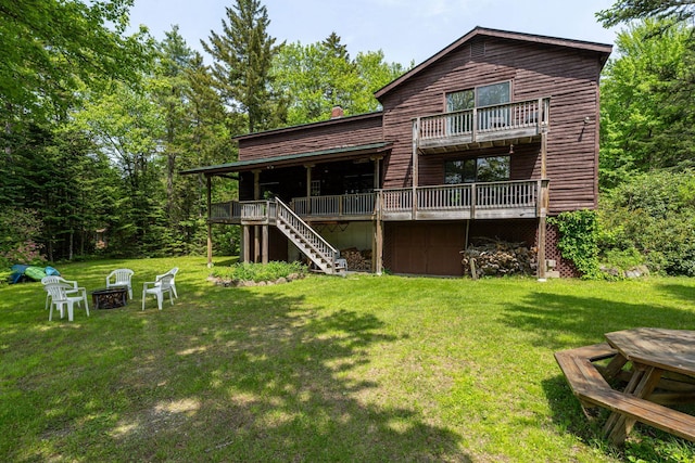 16 Mckinnon Rd, Washington, NH 03280 - back of house with an outdoor fire pit, stairs, a deck, and a lawn