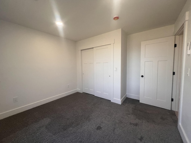 3 Crocket St, Rochester, NH 03867 - unfurnished bedroom with dark carpet, baseboards, and a closet